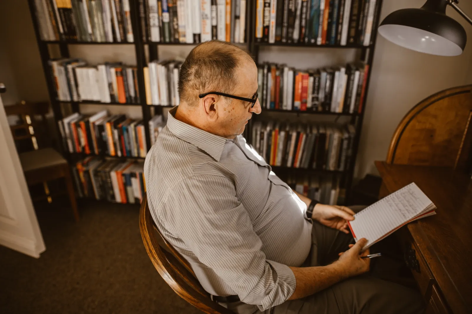 Older man reading practical lifestyle information at home